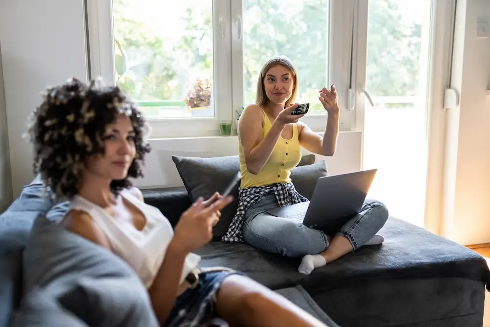 roommates watching tv and browsing the web